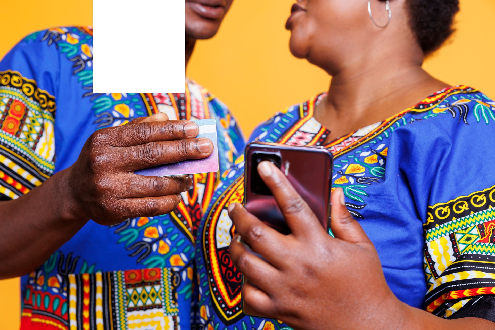 Hands holding smartphone and credit card